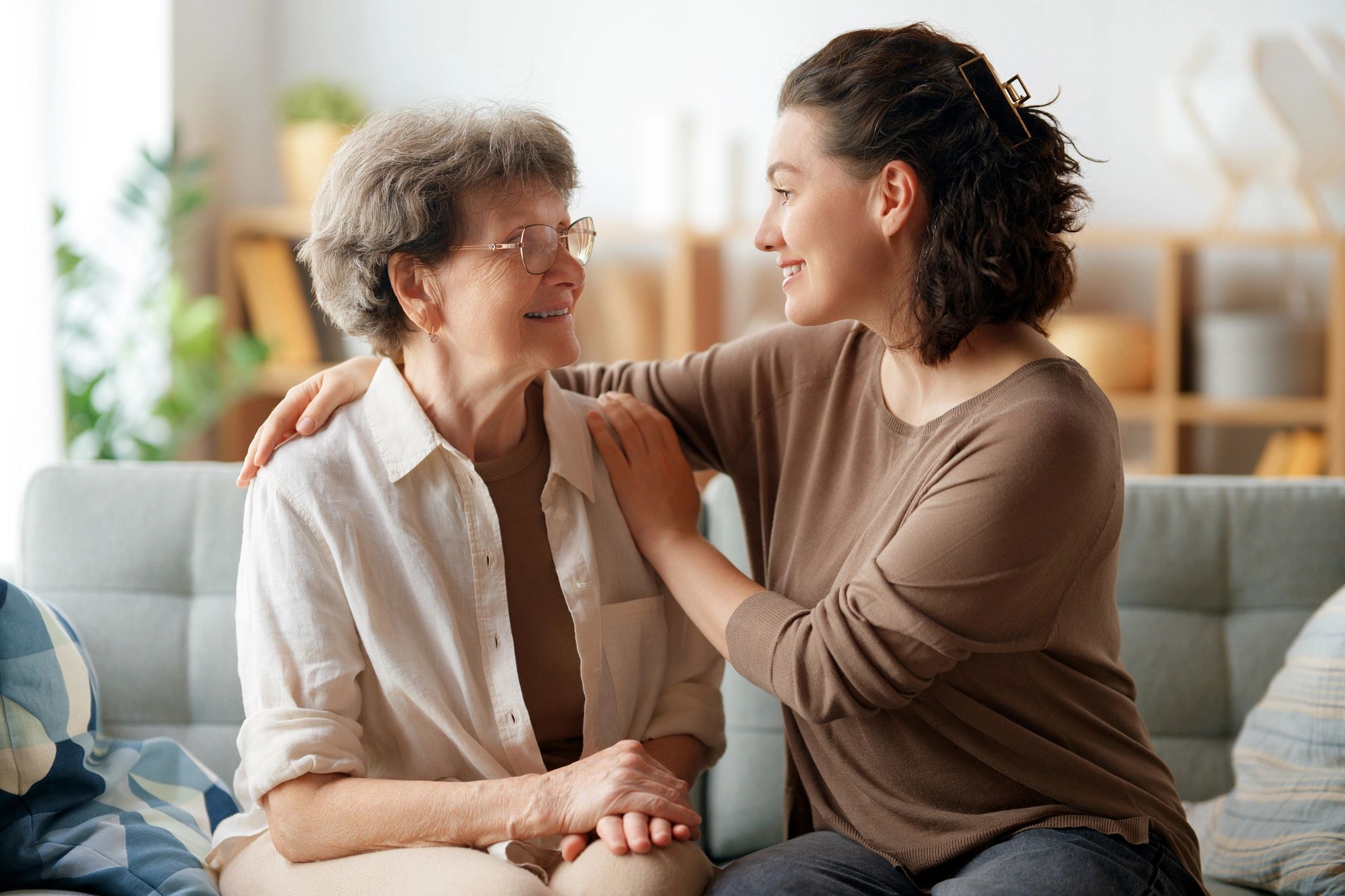 Caregiver spending quality time with an older woman at home